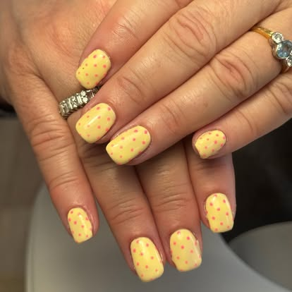 Yellow manicure with delicate dot nail art